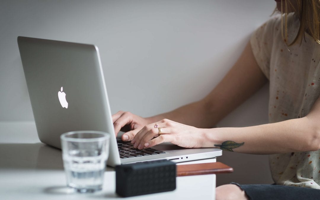 Woman writing on her laptop